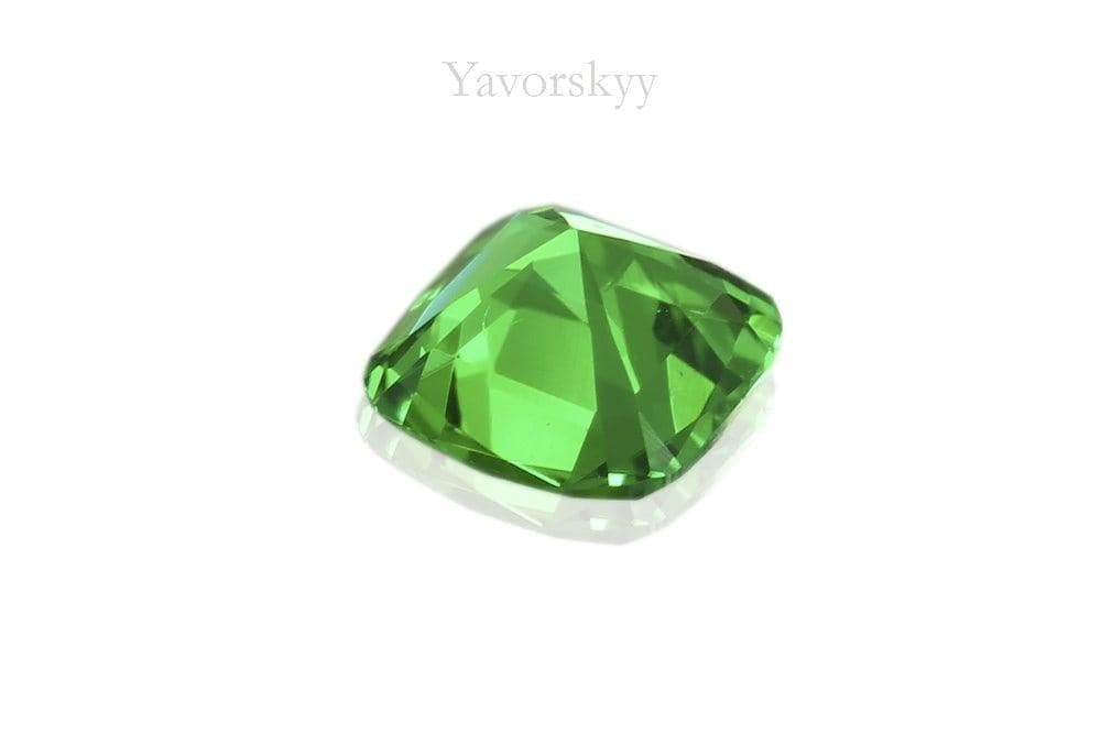 A back side picture of 0.13 ct tsavorite cushion